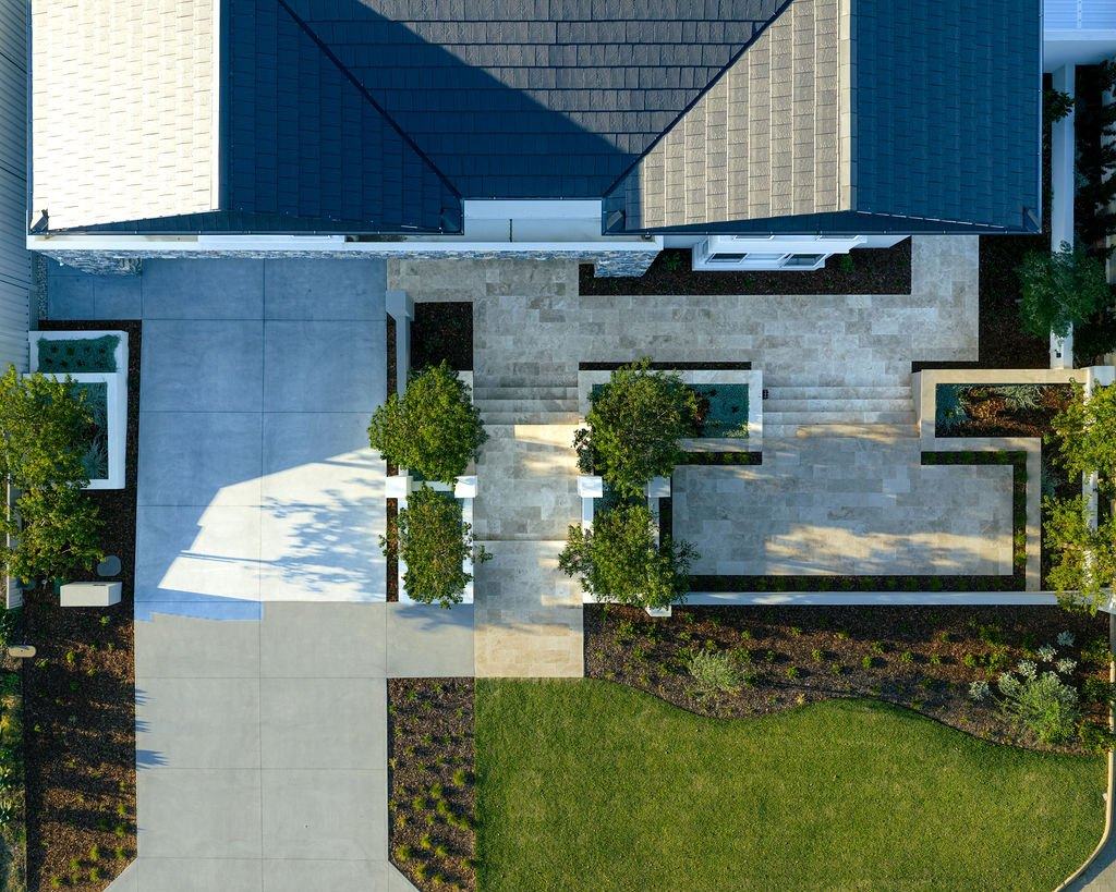 Overhead view of the front garden: driveway, travertine steps and terraces, planters and lawn