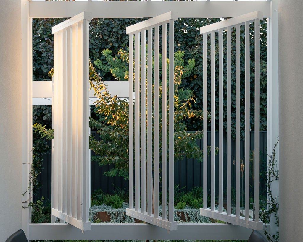 Folding white shutters opened onto the garden