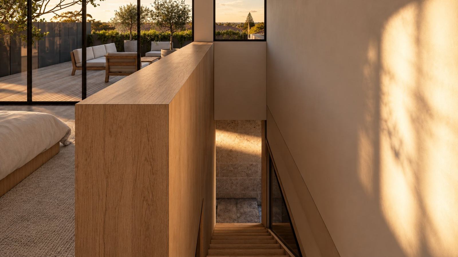 Timber stair balustrade beside the bedroom, with evening light on the wall