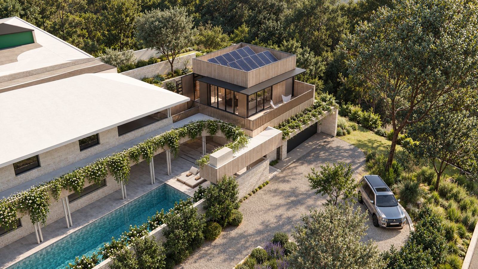 Aerial view of the extension with rooftop solar, the pool courtyard, gravel driveway and native planting