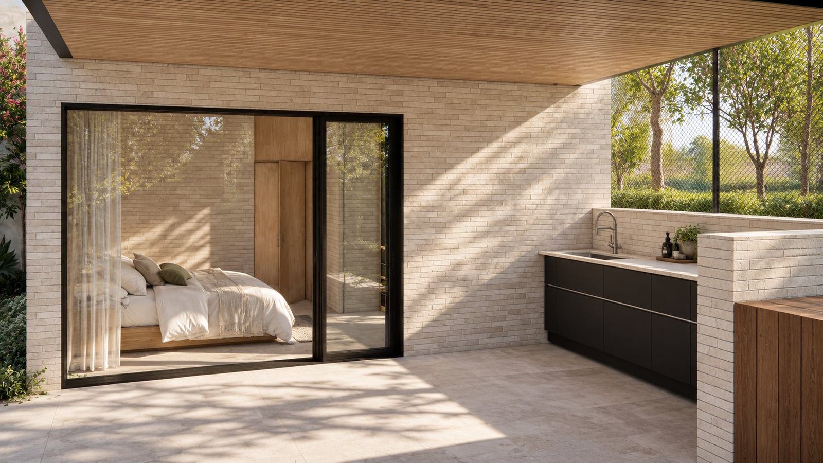 Covered outdoor kitchen beside a glass-walled guest bedroom